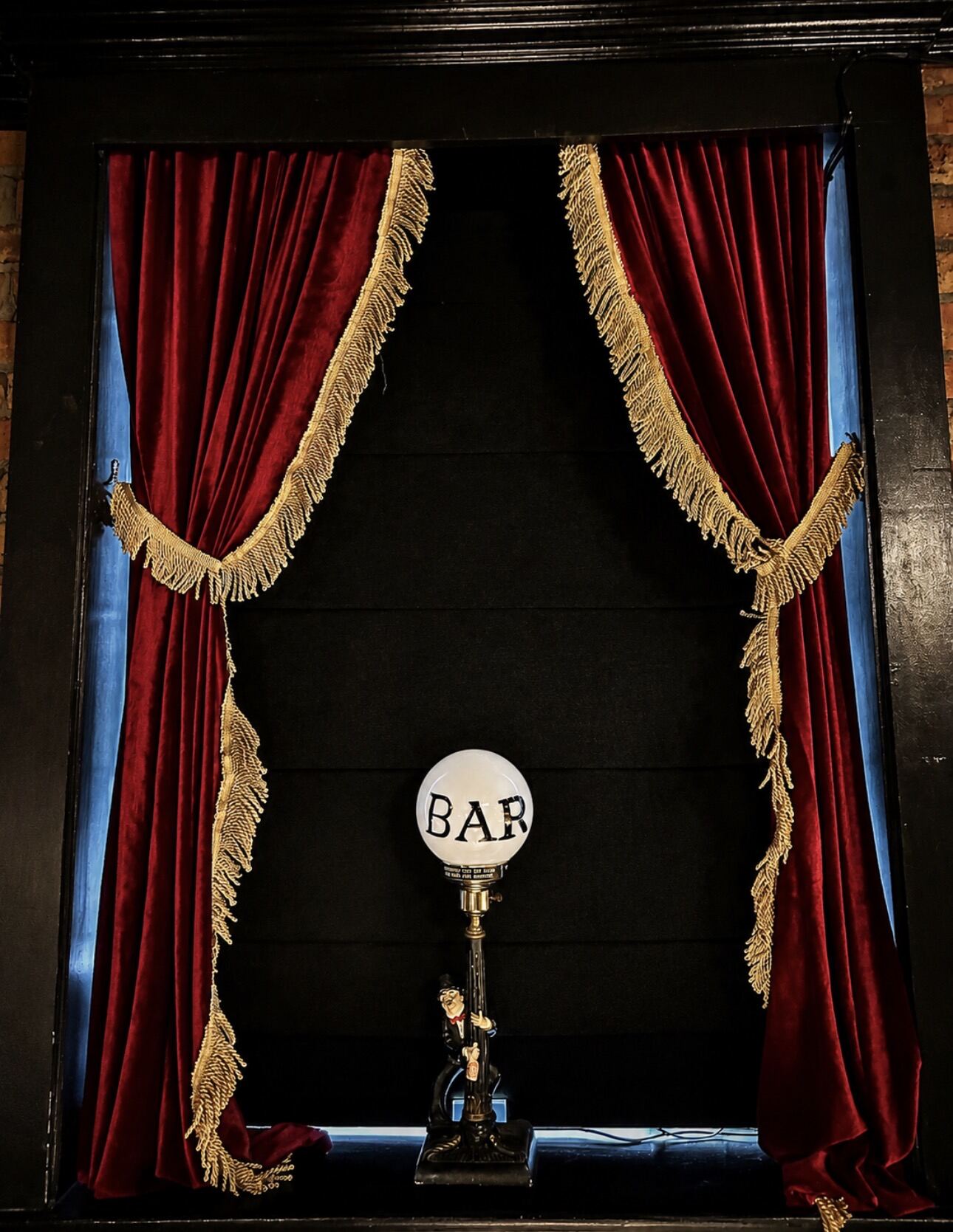 The BAR marquee behind red fringe curtains