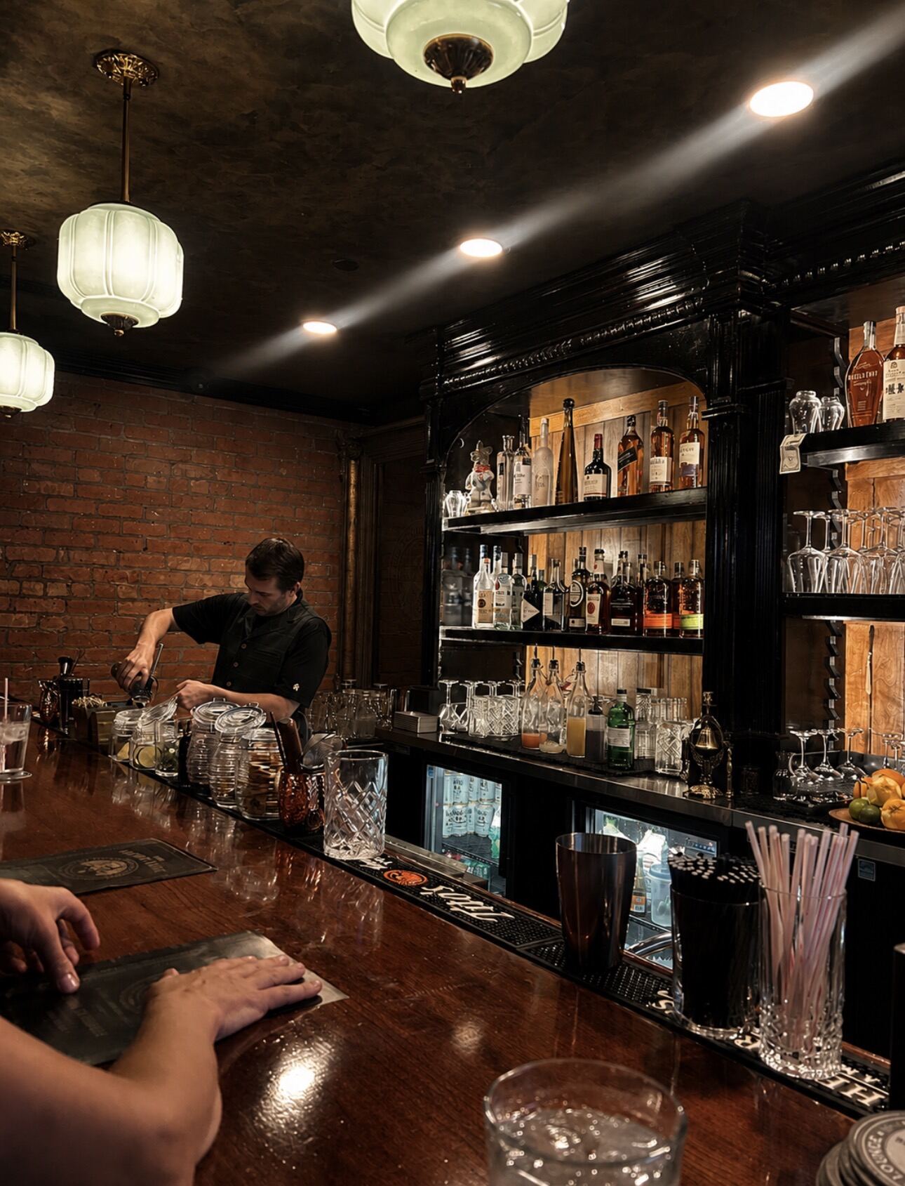 Behind the bar, mid-pour