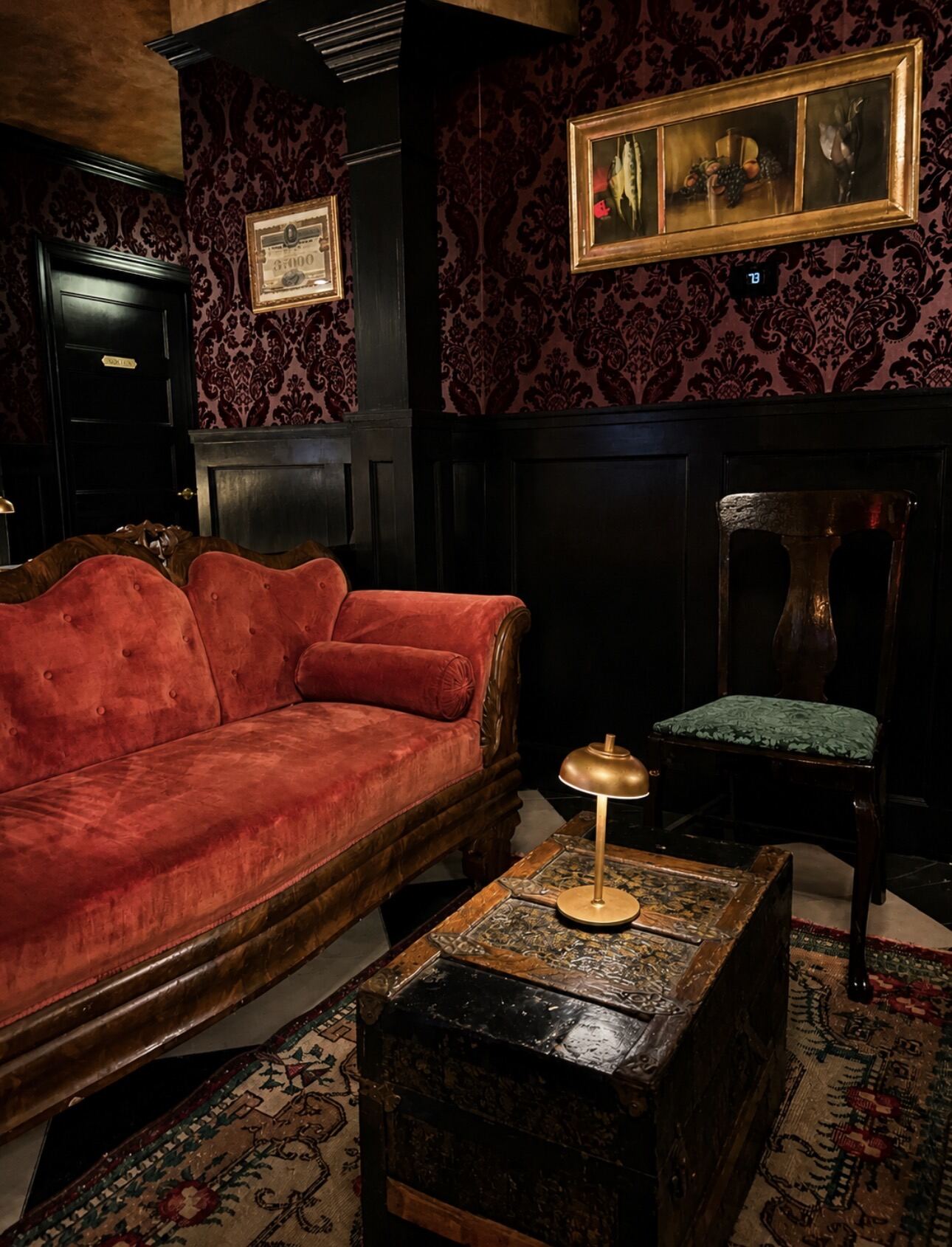 Red sofa and antique steamer trunk