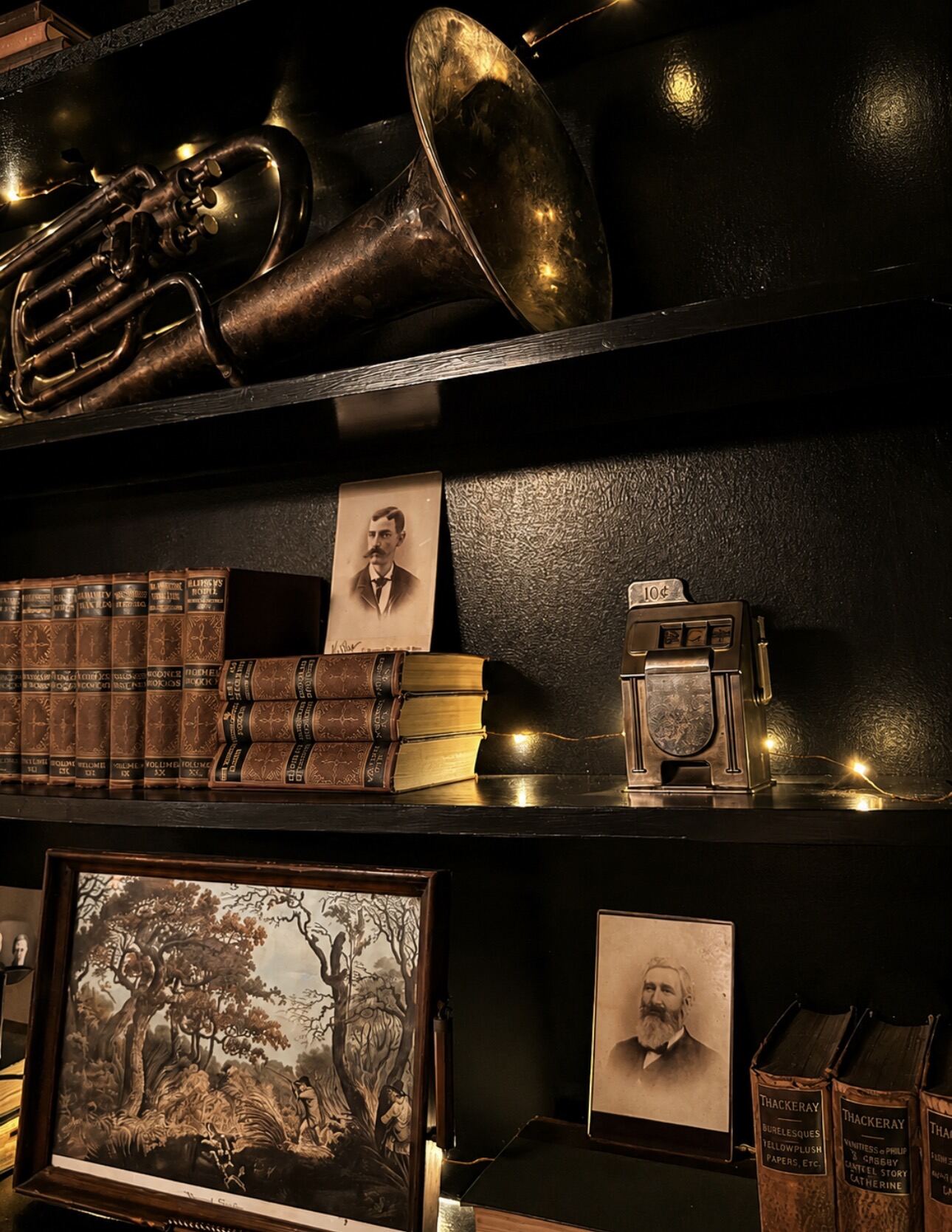 Old books and portraits on the shelves